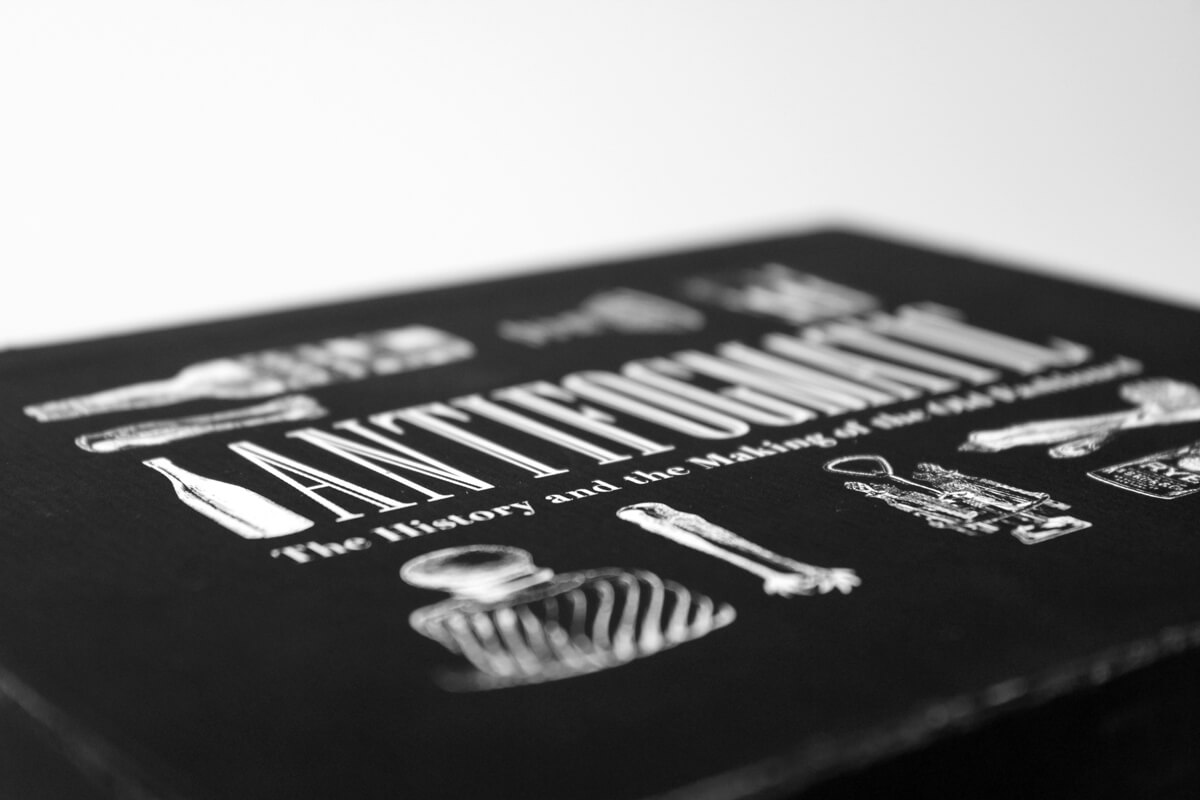 Detail photo of the top of the box that says 'Antifogmatic', 'The History and the Making of the Old Fashioned'
