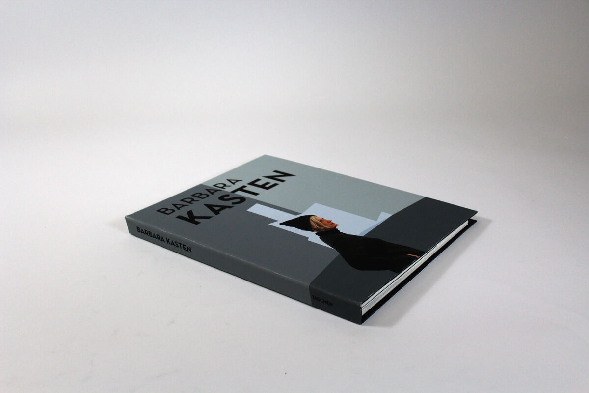 Cover of artist book of Barbara Kasten with her portrait wearing a black sweater and black winter hat