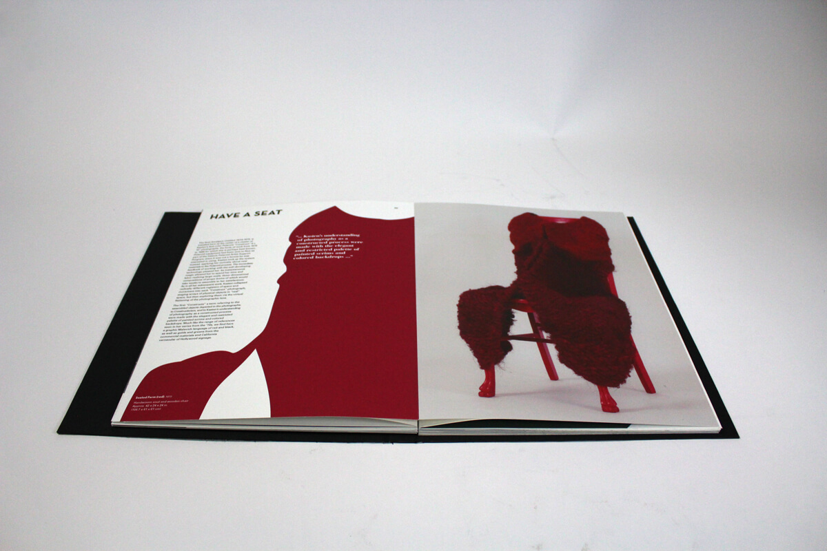 Spread of artist book of Barbara Kasten featuring a plastic red chair with red fuzzy fabric carefully draped over it.